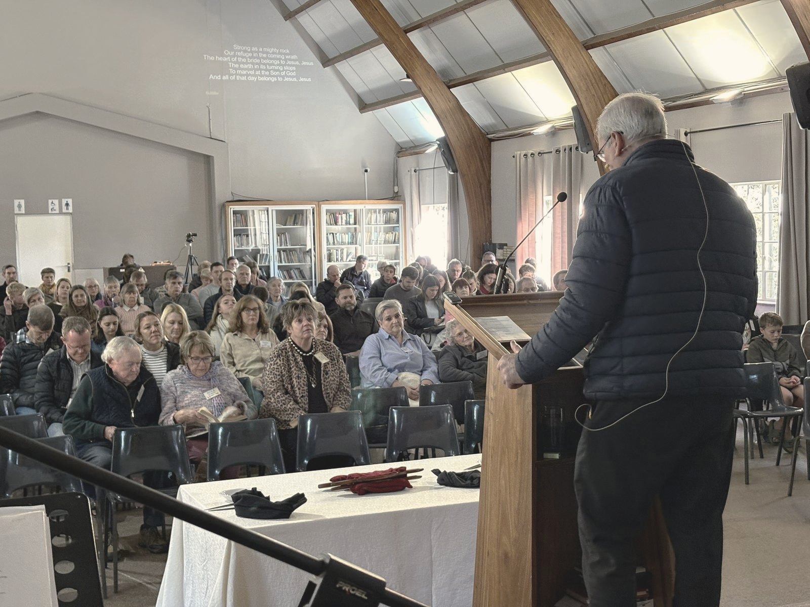 The preacher at the lectern facing a full church